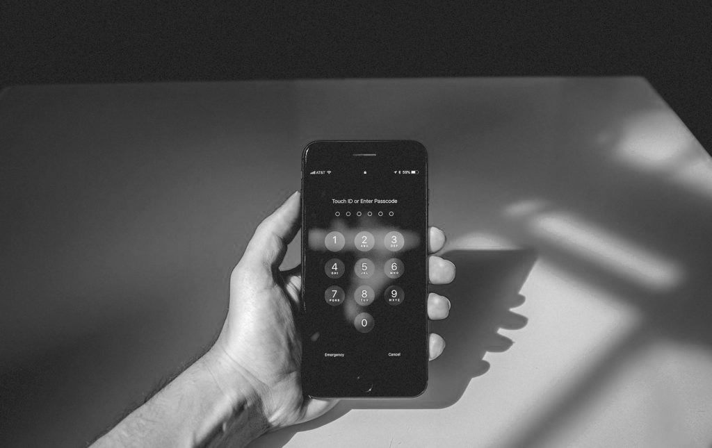 Taking mobile security in hand - a mobile phone asking for a passcode