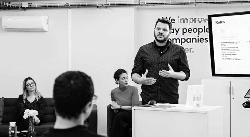 Emergn's Joao Ferreira stood in front of a room of people giving a presentation
